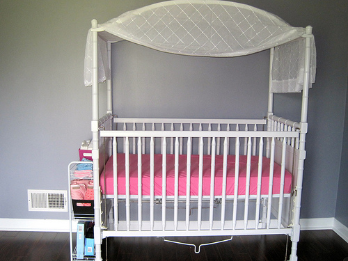 Pretty drapes add a special something to an ordinary cot.