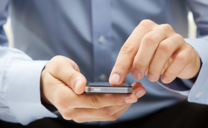 A businessman use a phone.