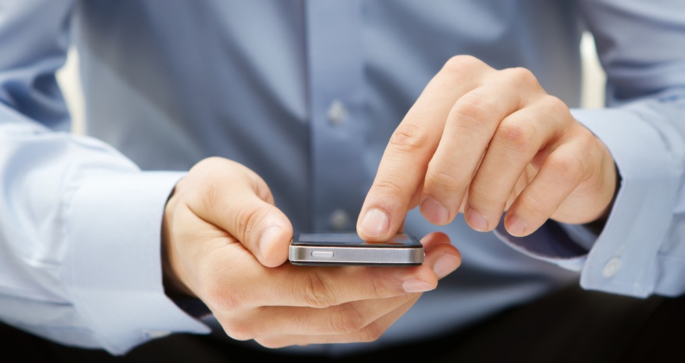 A businessman use a phone.